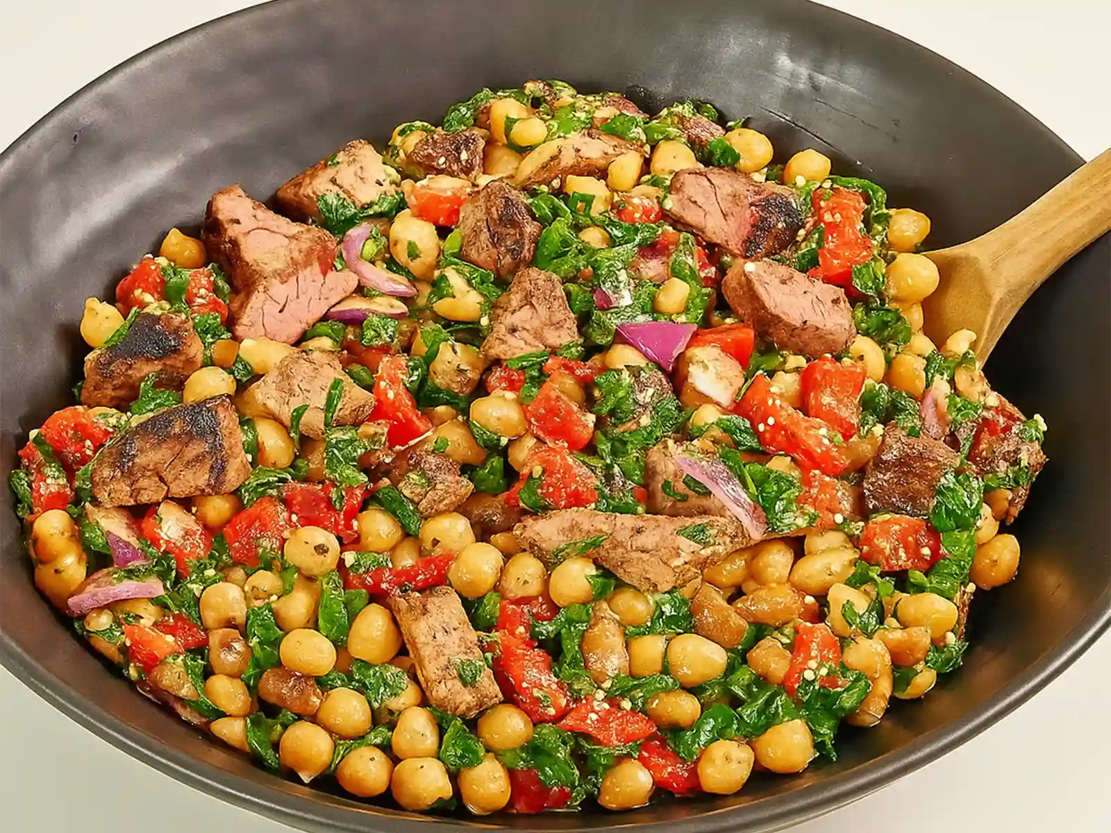 Steak chimichurri dense bean salad in a rustic bowl
