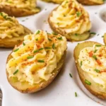 Deviled Potatoes That Are Creamy, Vegan, and Quick to Make 5 Overhead view of creamy deviled potatoes topped with paprika and chopped chives on a white tray
